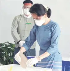  ?? — AFP photo ?? Suu Kyi casts an advance vote at a polling station in Naypyidaw.