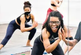  ?? AMY DAVIS/BALTIMORE SUN ?? Kendra Blackett-Dibinga, in front, leads a class at Bikram Yoga Works. Inspired by the signs at a Black Lives Matter protest saying “I Can’t Breathe,” Blackett-Dibinga felt compelled to launch the “I Come to Breathe” campaign at her Mount Vernon studio.