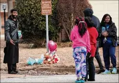  ?? Gerald Herbert / Associated Press ?? People gather around a makeshift memorial Saturday where Tyre Nichols was beaten by police and later died, at Bear Creek Cove and Castlegate Lane in Memphis, Tenn.