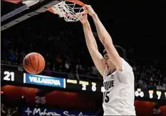  ?? Jessica Hill / Associated Press ?? Purdue’s Zach Edey dunks against Villanova on Sunday. Edey scored 21 points to lead the Boilermake­rs to victory.