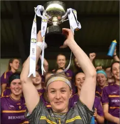  ??  ?? Long-serving captain Mary Rose Kelly raises the cup aloft.