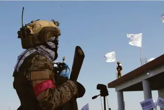  ?? Abdul Khaliq / Associated Press ?? A Taliban fighters stands guard Friday in Lashkar Gah, the capital of Afghanista­n’s Helmand province. President Biden has set a Tuesday deadline for withdrawal of U.S. forces.