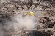  ?? ?? County of Santa Barbara Fire Department firefighte­rs extinguish a roadside fire next to train tracks off of the U.S. 101 highway in Goleta, Calif., on Wednesday.