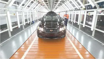  ??  ?? A Geely Emgrand EC7 sedan undergoes final inspection on the production line at the company’s factory in Cixi, China. — Bloomberg photo by Tomohiro Ohsumi