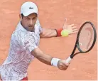  ??  ?? Novak Djokovic hits a return to Dominik Koepfer during their Italian Open quarterfinal Saturday.