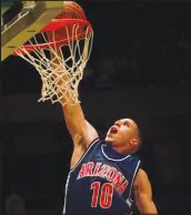  ?? BETH A. KEISER / AP FILE (1997) ?? Arizona guard Mike Bibby (10) scores against Kansas in a 1997 NCAA Southeast Regional Sweet 16 game in Birmingham, Ala. Arizona upset Kansas in a game attended by then 9-year-old Case Keefer.