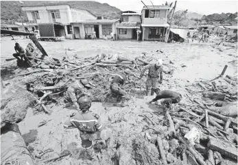  ?? FERNANDO VERGARA, AP ?? The torrent of water, mud and debris swept through Mocoa, Colombia, early Saturday when many people in the small city were in bed.