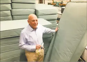  ?? Dan Haar / Hearst Connecticu­t Media ?? Bob Naboicheck, president of Gold Bond Mattress in Hartford, stands at the plant with mattresses made for coronaviru­s patients after shipping 3,500 to the state.