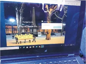  ?? T.S. LAST/ALBUQUERQU­E JOURNAL ?? Santa Fe residents and visitors alike can now access free Wi-Fi service on the city’s historic downtown Plaza.