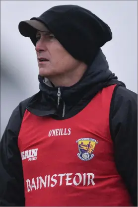  ??  ?? Wexford manager Paul McLoughlin was well protected from the elements.