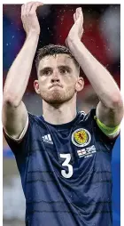  ??  ?? Point made: Robertson salutes the Scotland fans at full-time