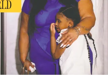  ?? LUCAS JACKSON / REUTERS ?? George Floyd’s six-year-old daughter Gianna is embraced by her mother Roxie Washington before speaking about her father at Minneapoli­s City Hall on Tuesday. Floyd died in police custody last week.