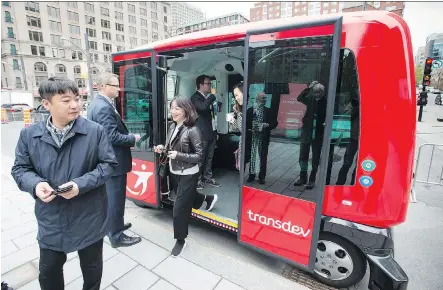  ?? PAUL CHIASSON/THE CANADIAN PRESS ?? Passengers disembark from an autonomous bus after taking a short ride Monday in Montreal. The driverless vehicle is being featured at a transporta­tion conference. Calgary council is discussing the potential effects of new technology on city...