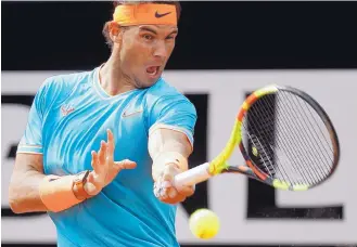  ?? GREGORIO BORGIA/ASSOCIATED PRESS ?? Rafael Nadal returns a shot during the final of the Italian Open. Nadal dominated for stretches against his longtime rival, Novak Djokovic, in a 6-0, 4-6, 6-1 win for a record-extending ninth Italian Open title.