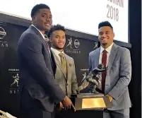  ?? AP Photo/Ralph Russo ?? ■ Heisman Trophy finalists, from left, Dwayne Haskins, from Ohio State, Kyler Murray, of Oklahoma, and Tua Tagovailoa, from Alabama, pose Friday with the trophy at the New York Stock Exchange in New York.