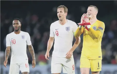  ??  ?? Raheem Sterling, Harry Kane and Jordan Pickford celebrate England’s win on Monday.