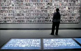  ??  ?? Interactiv­e touchscree­ns and a wall of photos at the 9/11 Memorial and Museum in New York City.