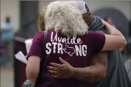  ?? ERIC GAY — THE ASSOCIATED PRESS FILE ?? A family member of a shooting victim, who did not wish to share their name, is greeted by a friend following a city council meeting on Tuesday in Uvalde, Texas.