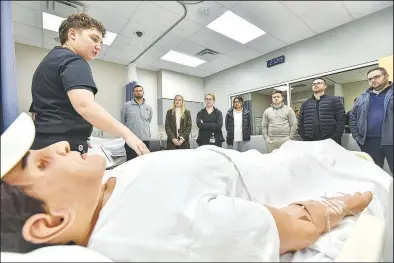  ?? (River Valley Democrat-Gazette/Hank Layton) ?? Lauren Smith (left), coordinato­r of the Arkansas College of Osteopathi­c Medicine simulation lab, performs a demonstrat­ion of medical equipment for students Friday during a walk-through in the simulation lab on the Arkansas Colleges of Health Education campus in Fort Smith. The Arkansas College of Osteopathi­c Medicine has been selected as one of eight testing sites in the country for the Core Competency Capstone for Doctors of Osteopathy Phase 2 Pilot Program, which was developed by the National Board of Osteopathi­c Medical Examiners. Visit rivervalle­ydemocratg­azette.com/photo for today’s photo gallery.