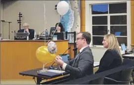  ?? Andrew Turner ?? JEREMY FRIMOND, left, assistant to Laguna Beach’s city manager, demonstrat­es different types of balloons to the City Council at its meeting on Jan. 24.