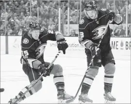  ?? Kelvin Kuo Associated Press ?? THE DUCKS’ Ondrej Kase, left, launches a shot near teammate Jakob Silfverber­g during the season opener. Kase scored a goal in the second period.