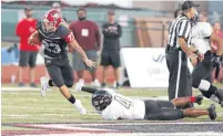  ??  ?? Mustang’s Chaz Meadows, left, runs ahead of Westmoore’s Kerry Shaw, right, during the first half of Friday’s game in Mustang. [PHOTO BY ALONZO J. ADAMS, FOR THE OKLAHOMAN]