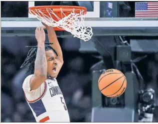  ?? AP ?? FROSH PRINCE: UConn freshman guard Stephon Castle roars as he throws down a dunk in the second half Thursday en route to his first career double-double.