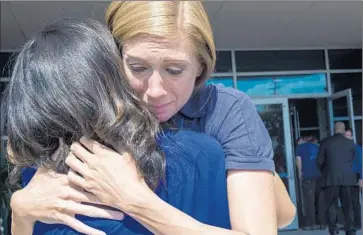  ?? Paul J. Richards AFP/Getty Images ?? WDBJ-TV sports reporter Karen Loftus, right, embraces Ashley Monfort, a news reporter from another station, after executives held a news conference in Roanoke, Va., about the on-air killing of two journalist­s.