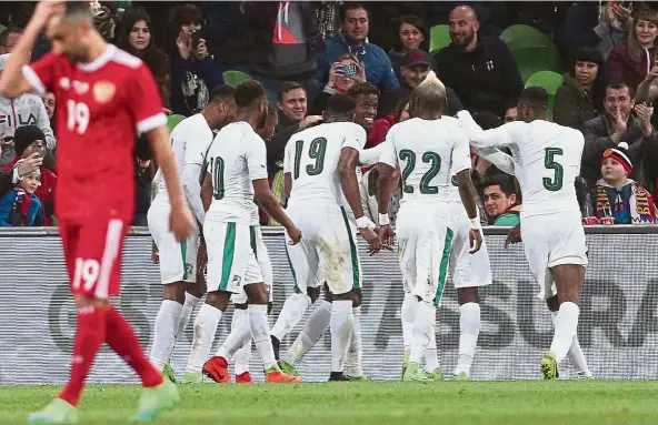  ?? AFP ?? Happy moment: Ivory Coast players mob Wilfried Saha (centre) after he scored against Russia in a friendly in Krasnodar on Friday. Ivory Coast won 2- 0. —