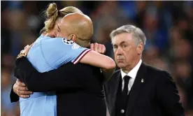  ?? Photograph: Oli Scarff/AFP/Getty Images ?? Carlo Ancelotti looks on as Pep Guardiola and Erling Haaland embrace after Manchester City’s win over Real Madrid last season.
