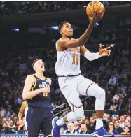  ?? Andres Kudacki / Associated Press ?? The Knicks’ Frank Ntilikina drives to the basket against the Jazz’s Jonas Jerebko on Nov. 15 in New York.