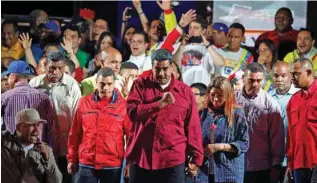  ?? - Reuters ?? JUBILANT: Venezuela’s President Nicolas Maduro stands with supporters during a gathering after the results of the election were released, outside of the Miraflores Palace in Caracas, Venezuela, on May 20, 2018.