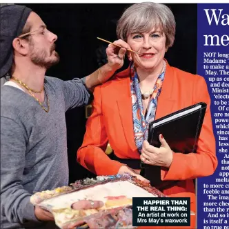  ??  ?? HAPPIER THAN THE REAL THING: An artist at work on Mrs May’s waxwork