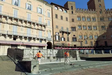  ??  ?? Le operazioni di sanificazi­one di piazza del Campo a Siena, ieri mattina