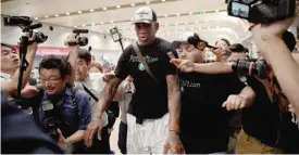  ??  ?? BEIJING: Former NBA basketball player Dennis Rodman of the US is mobbed by the media as he walks out from the arrival gate, returning from his trip to North Korea at Beijing’s internatio­nal airport yesterday. — AFP