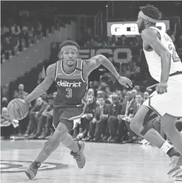  ??  ?? Wizards guard Bradley Beal (3) drives to the basket as Knicks center Mitchell Robinson defends on March 10. Beal said players are concerned about being isolated at the ESPN Disney Wide World of Sports Complex near Orlando, where their leaving is discourage­d.