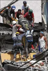  ?? REBECCA BLACKWELL / ASSOCIATED PRESS ?? An injured man is pulled from a building that collapsed in Tuesday’s earthquake in Mexico City. The quake appeared unrelated to one Sept. 7 that hit off Mexico’s southern coast and also was felt strongly in the capital. Much of the city is built on...