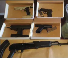  ?? STOCKTON POLICE DEPARTMENT VIA AP ?? This Thursday photo released by the Stockton Police Department’s Gang Suppressio­n Unit shows some of the 35 seized weapons included 10 assault rifles, after nearly 50 people were arrested in a crackdown on gangs in Stockton.