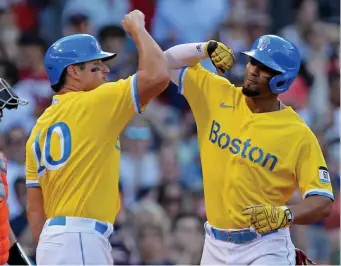  ?? StuARt CAHiLL pHotos / HeRALd stAff ?? MONSTER GAME: Xander Bogaerts, right, is congratula­ted on his three-run homer by Hunter Renfroe in the sixth inning against the Orioles at Fenway Park on Saturday afternoon.