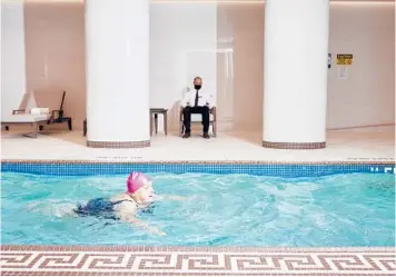  ?? GABBY JONES/THE NEW YORK TIMES ?? Gisela Vellahn, a resident at the Watermark at Brooklyn Heights, a new luxury senior living community, swims in the heated pool Oct. 27. A new crop of luxury senior housing is turning retirement into a five-star resort stay.