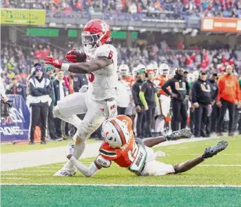  ?? Mike Stobe/getty Images ?? Rutgers’ Kyle Monangai rushes for a second-quarter touchdown against Markeith Williams of Miami during the Bad Boy Mowers Pinstripe Bowl at Yankee Stadium on Thursday in New York.