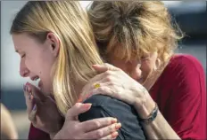  ??  ?? Santa Fe High School student Dakota Shrader is comforted by her mother Susan Davidson following a shooting at the school on Friday in Santa Fe, Texas. STUART VILLANUEVA/THE GALVESTON COUNTY DAILY NEWS VIA AP