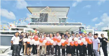  ??  ?? Lawrence ( centre) officiates at the launching of the show house.