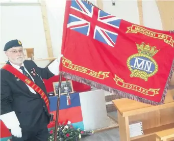  ??  ?? Honouring his service A standard bearer for the Merchant Navy delivers a flag at Derek’s funeral