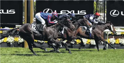 ?? PHOTO: GETTY IMAGES ?? Holding on . . . Jye McNeil riding Twilight Payment wins the 2020 Melbourne Cup, ahead of Kerrin McEvoy riding No 21 Tiger Moth and Jamie Kah riding No 12 Prince Of Arran at Flemington Racecourse in Melbourne, yesterday.