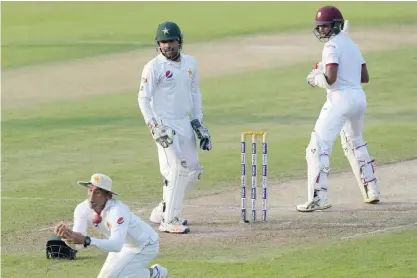  ??  ?? SHARJAH: Pakistani cricketer Younis Khan (L) drops a catch off West Indies’ batsman Shane Dowrich (R) as wicketkeep­er Sarfraz Ahmed (C) looks on on the second day of the third and final Test between Pakistan and the West Indies at the Sharjah Cricket...