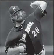  ?? AP/MATTHEW STOCKMAN ?? Milwaukee Brewers starter Wade Miley allowed three hits over 4 2/3 innings as he kept the Colorado Rockies in check in Sunday’s 6-0 victory in Game 3 of the National League division series in Denver. The Brewers advance to their first NL Championsh­ip Series since 2011.