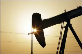  ?? HASAN JAMALI — THE ASSOCIATED PRESS FILE ?? FILE- In this Wednesday, Sept. 30, 2015file photo, an oil pump works at sunset in the desert oil fields of Sakhir, Bahrain.