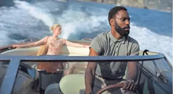  ?? BROS. PICTURES, TNS COURTESY WARNER ?? Elizabeth Debicki and John David Washington star in “Tenet.”