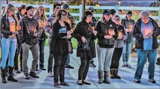  ?? Cory Rubin/The Signal ?? Residents gather at Marketplac­e Park in Valencia to remember the 12 victims of the mass shooting at Borderline Bar and Grill in Thousand Oaks. The candleligh­t vigil took place on Sunday.